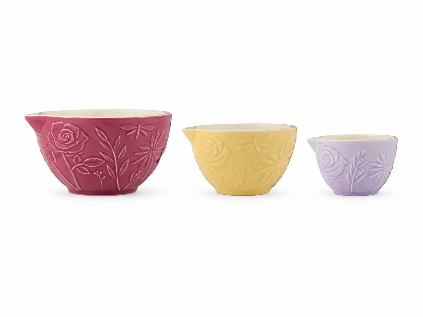 Mason Cash In The Meadow set of three measuring cups in pink, yellow and lavender, featuring embossed floral designs on a white background.